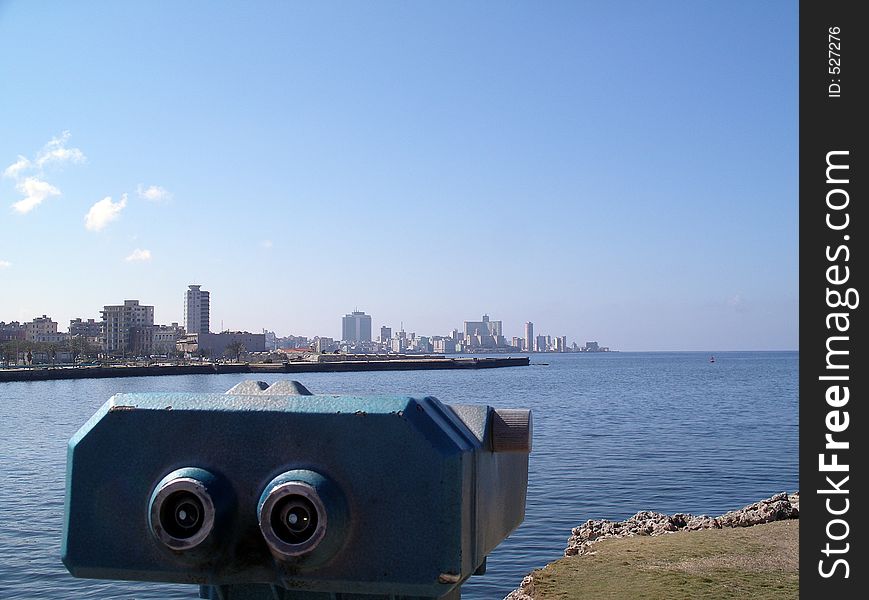 Look at Havana. Havana panorama city view. Focus mostly on the front subject of the binoculars. Havana city still very well in focus and in field of view.