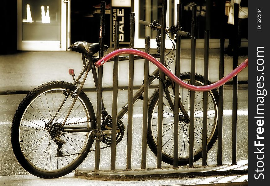 Shot of a mountain bike leaning against a fence. Shot of a mountain bike leaning against a fence