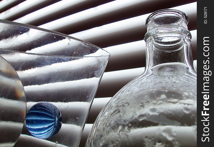 Still life with blue glass ball and bottles