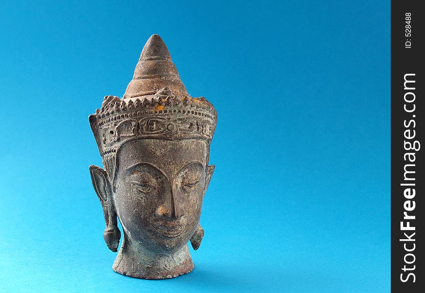 Buddhist head statue over blue
