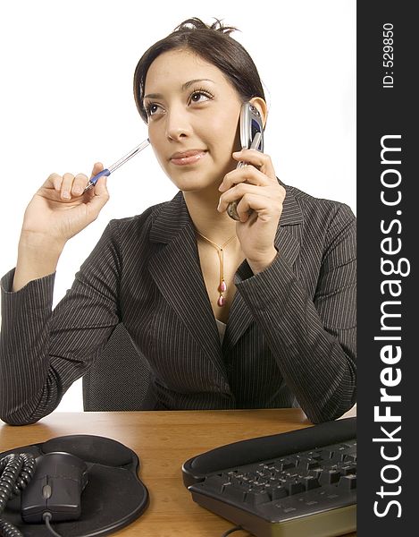 Young executive girl having an inspiring business conversation over the phone in the office. Young executive girl having an inspiring business conversation over the phone in the office