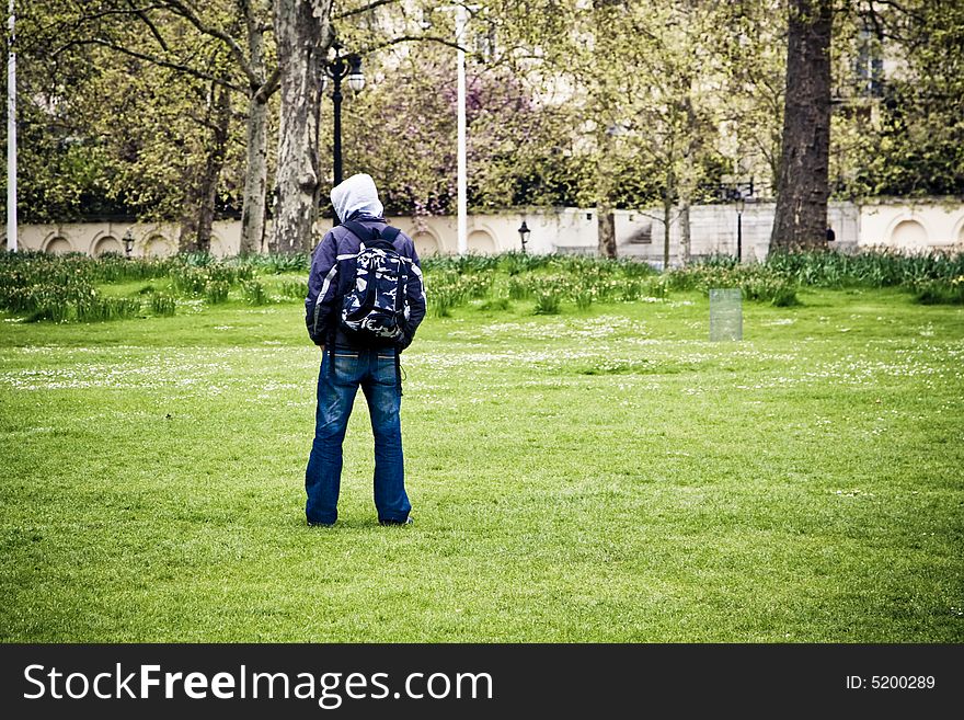Unrecognizable man standing in the middle of the park. Unrecognizable man standing in the middle of the park