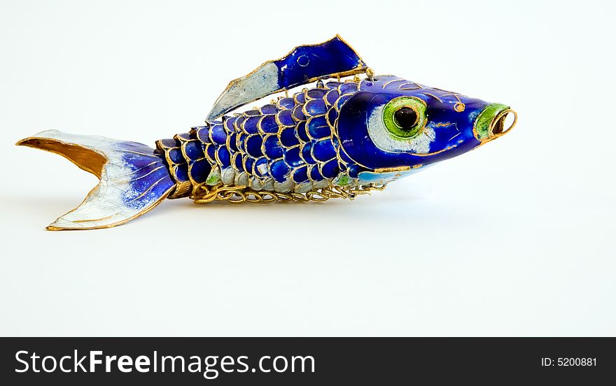 A beautifully colored metal fish trinket. A beautifully colored metal fish trinket