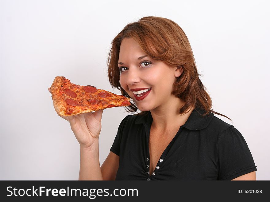 beautiful girl eating a pizza slice wearing a black t-shirt. beautiful girl eating a pizza slice wearing a black t-shirt