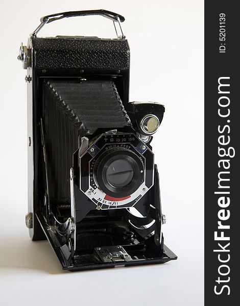 An old folding camera in the open position