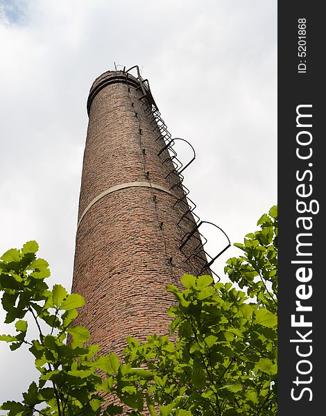 Chimney under white cloudscape in summer times. Chimney under white cloudscape in summer times