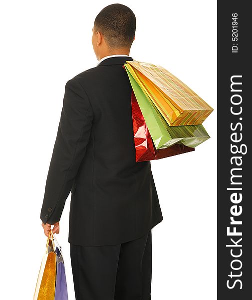 Isolated shot of male shopper from his back carrying many shopping bags. Isolated shot of male shopper from his back carrying many shopping bags