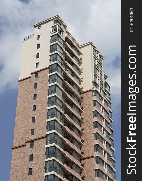 Apartment building under cloudscape in summer times