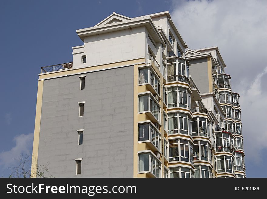 Apartment building under cloudscape in summer times