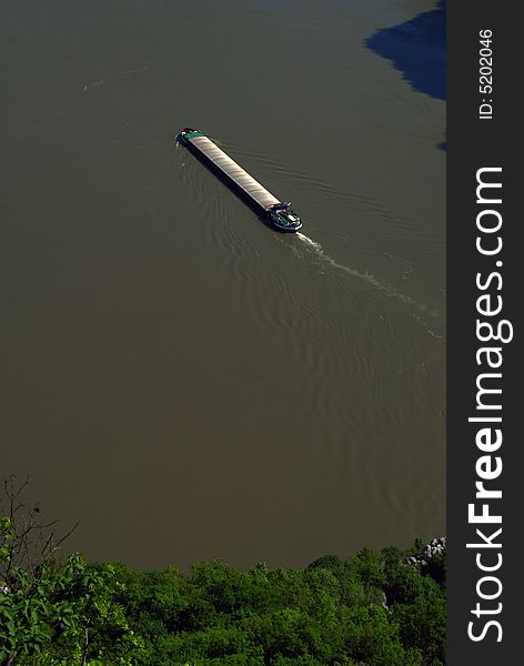 Commercial Ship flowing down the Danube river at Cazanele Mari gorge. Commercial Ship flowing down the Danube river at Cazanele Mari gorge