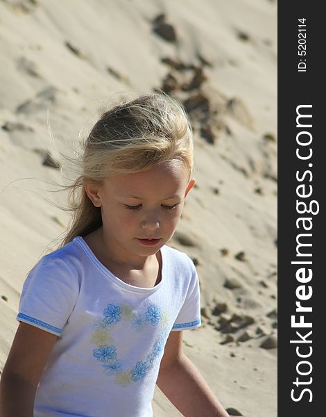 A beautiful white caucasian girl child with a sad expression on her face. A beautiful white caucasian girl child with a sad expression on her face