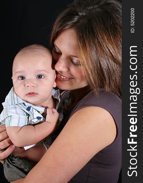 Mother and Baby boy on a black background. Mother and Baby boy on a black background