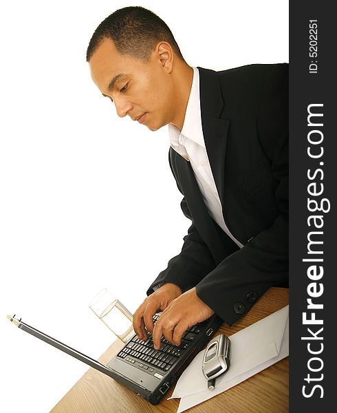 Isolated shot of handsome business man seriously working with his laptop. Isolated shot of handsome business man seriously working with his laptop