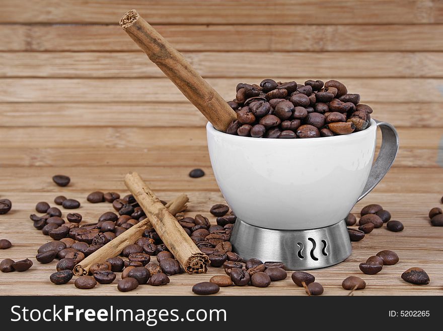 Cup, coffee beans and cinnamon stick