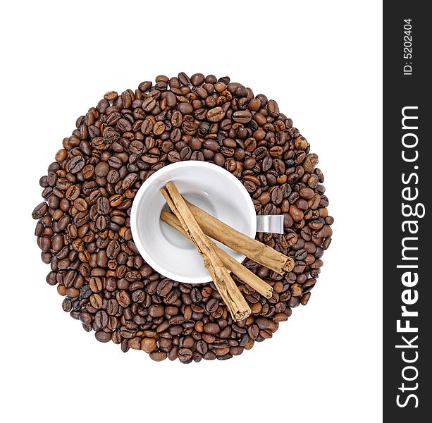 Coffee beans, white cup and cinnamon sticks isolated on white