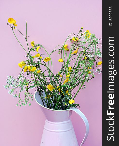 Hand picked wild flowers from the meadow,in a pink enamel jug