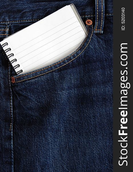 A notebook in the back pocket of denim trousers. A notebook in the back pocket of denim trousers.