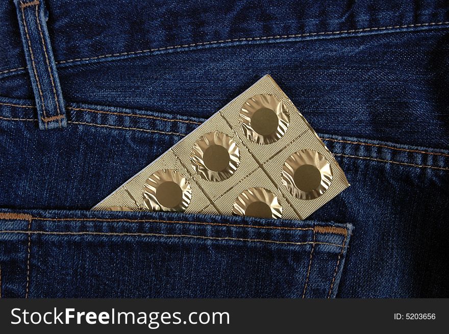 Tablets in the pocket of denim trousers. Tablets in the pocket of denim trousers.