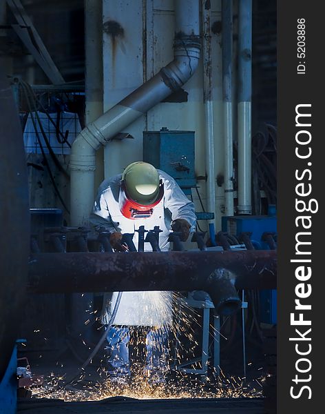 Male welder focused on job at factory