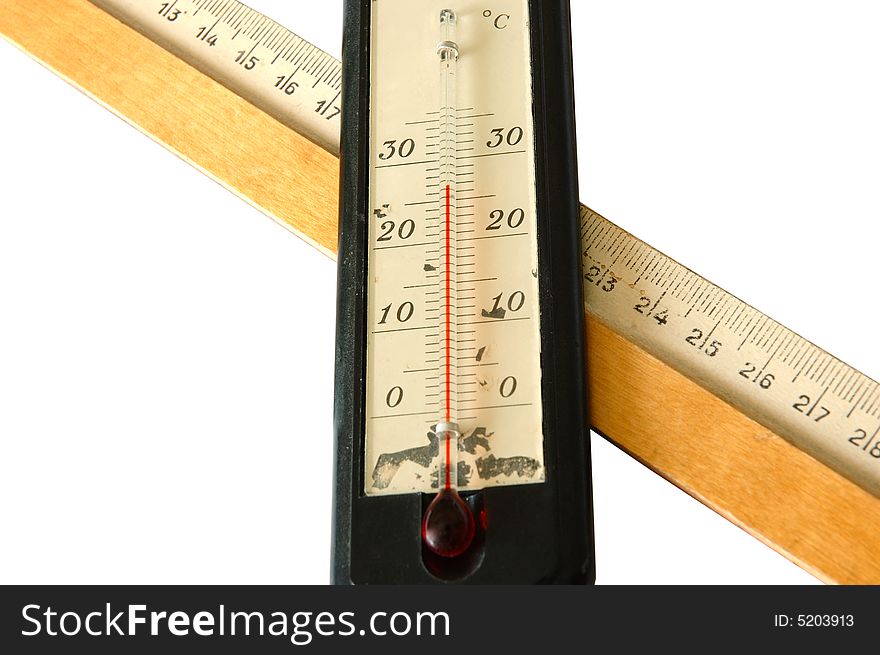 Old alcohol thermometer with Celsius scale and old wooden ruler in isolated background. Old alcohol thermometer with Celsius scale and old wooden ruler in isolated background.