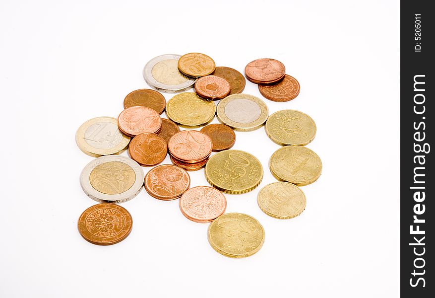 Different coins arranged unsorted over a white background. Different coins arranged unsorted over a white background