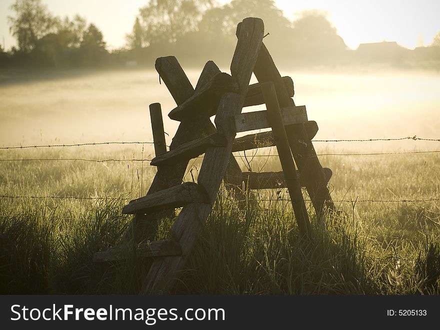 Morning fog and ladder at the meadow