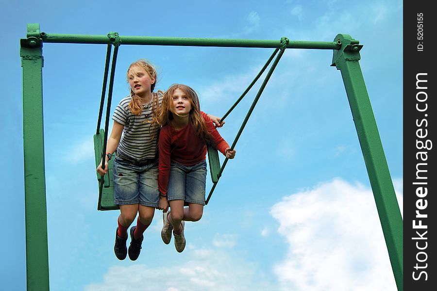 Two funny girls flying on the swing. Two funny girls flying on the swing