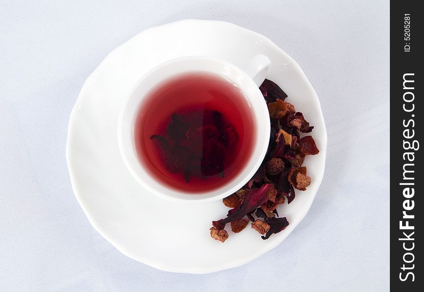 Cup of red flower tea on a white background. Cup of red flower tea on a white background