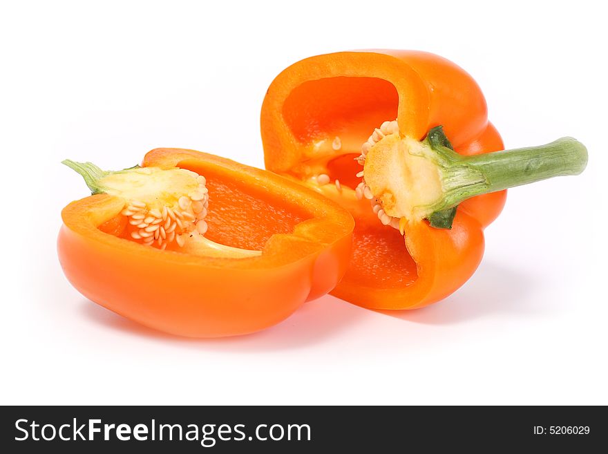Two half orange sweet pepper isolated on white