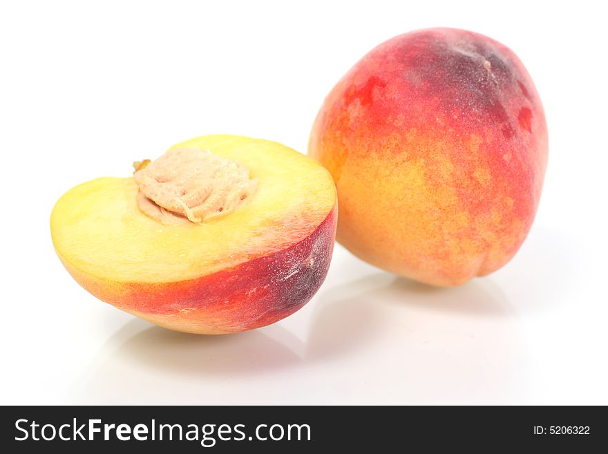 Two fresh peach on white background