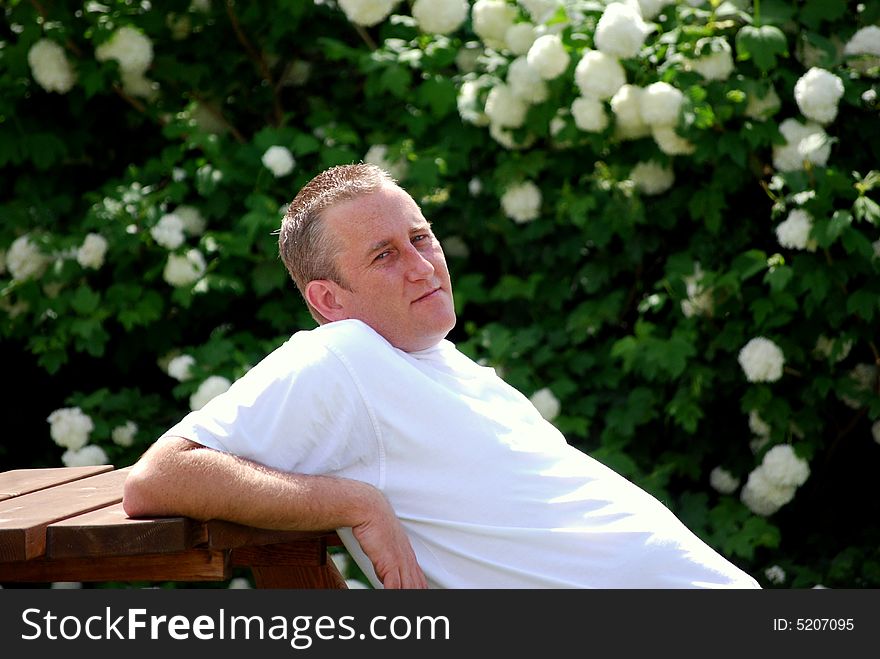 Man relaxing in the garden in summertime