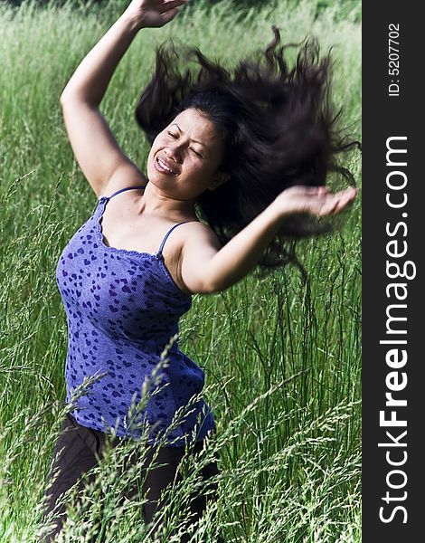 Girl dancing  in grass field. Girl dancing  in grass field