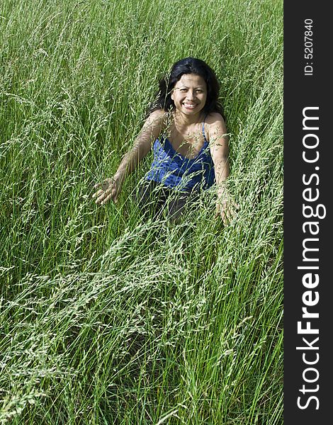 Girl sitting  in grass field. Girl sitting  in grass field