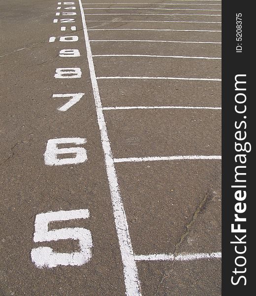 Dividing number painted on asphalt on stadium