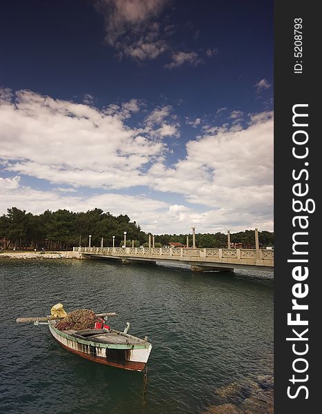 Fishing boat moored next to a bridge at the edge of Adriatic