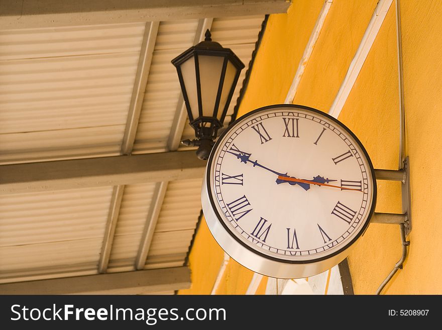 Old clock under a lantern