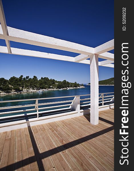 Metal structure to hold a roof build on a wooden deck next to the sea. Metal structure to hold a roof build on a wooden deck next to the sea.