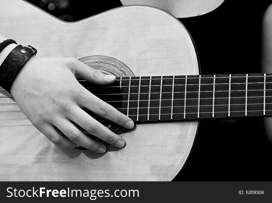 Hand on guitar, black and white. Hand on guitar, black and white.