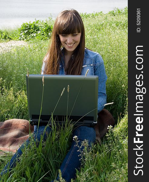 Happy girl with laptop outdoor