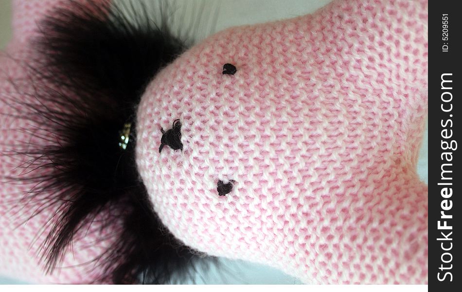 Pink hand-knit bunny in black feather. Pink hand-knit bunny in black feather