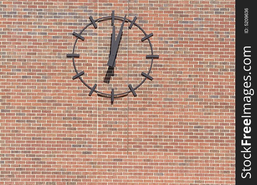 A clock just after noon on a brick wall. A clock just after noon on a brick wall