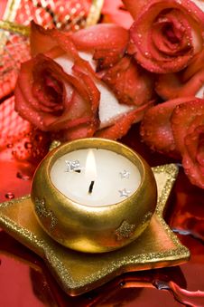Golden Candle With Red Roses Stock Image