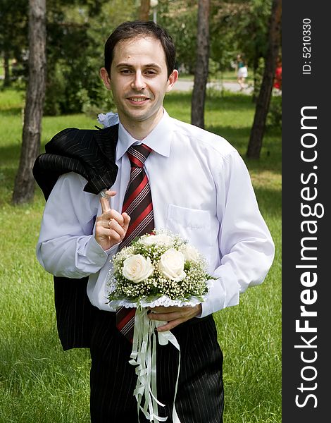 Well-dressed groom with rose bouquet. Well-dressed groom with rose bouquet
