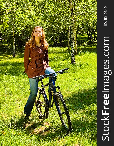 Thinking woman on bicycle in the spring forest. Thinking woman on bicycle in the spring forest