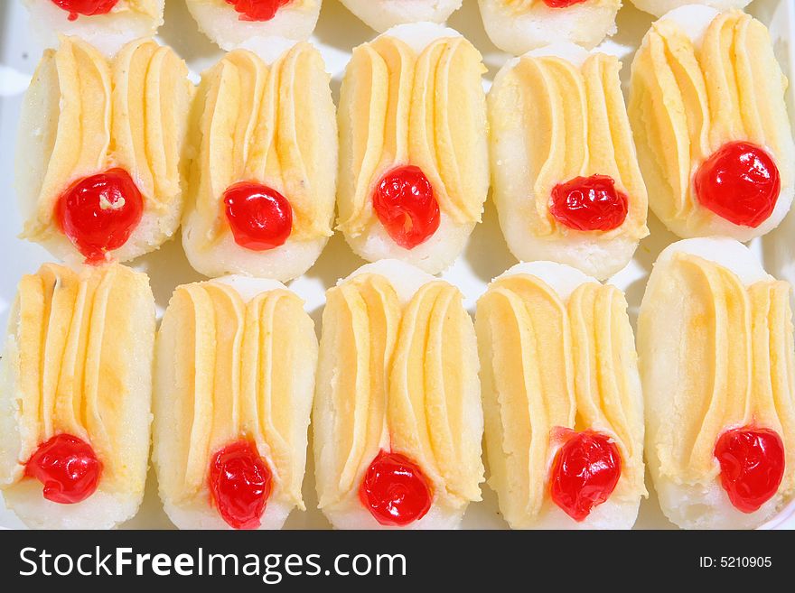 delicious indian sweets in a yellow and white long shape