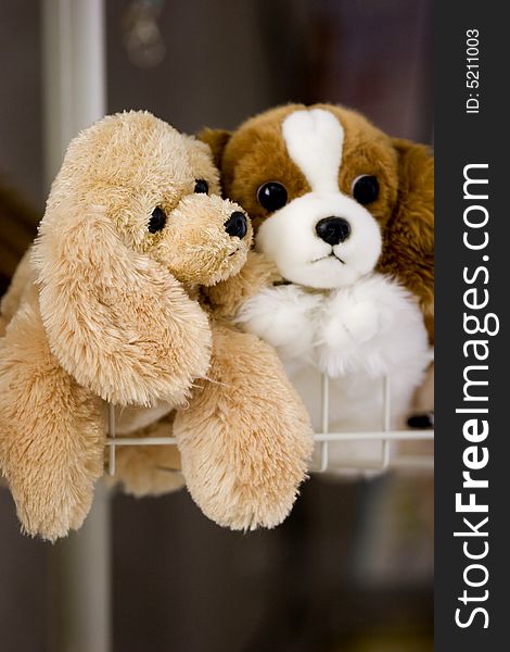 Two stuffed puppy toys in holding basket. Two stuffed puppy toys in holding basket