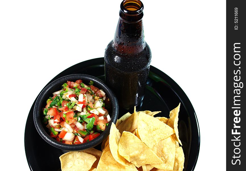 A cold beer woith chips and salsa on a serving tray. A cold beer woith chips and salsa on a serving tray.