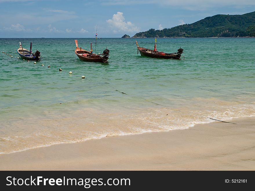 Three wooden boats at Patong beach, Phuket, Thailand