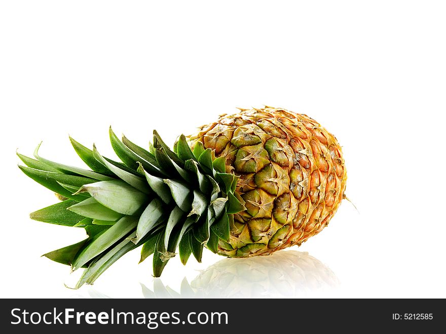 Fresh ripe pineapple over white background with reflection