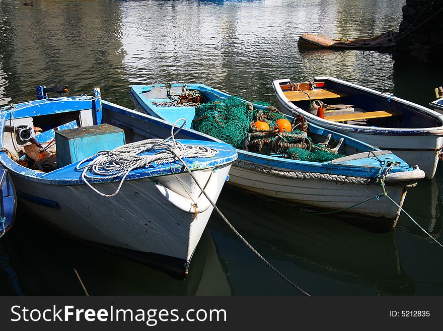 Old cog fishing boats white and blue, with fishing net, Cornwell, England